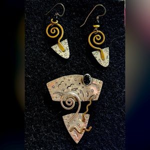 Silver copper earring with matching pin.